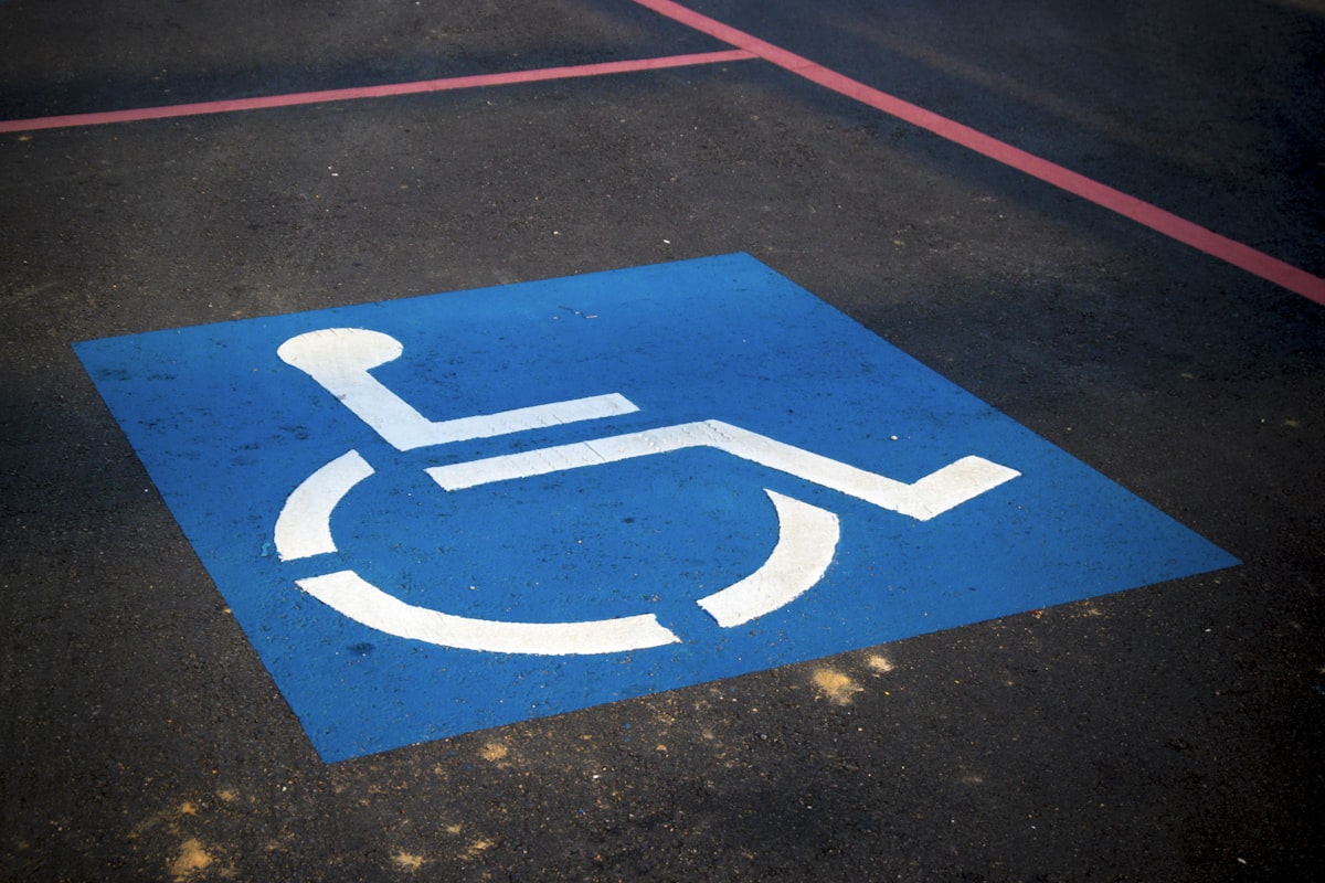 Blue disabled parking symbol painted on road surface
