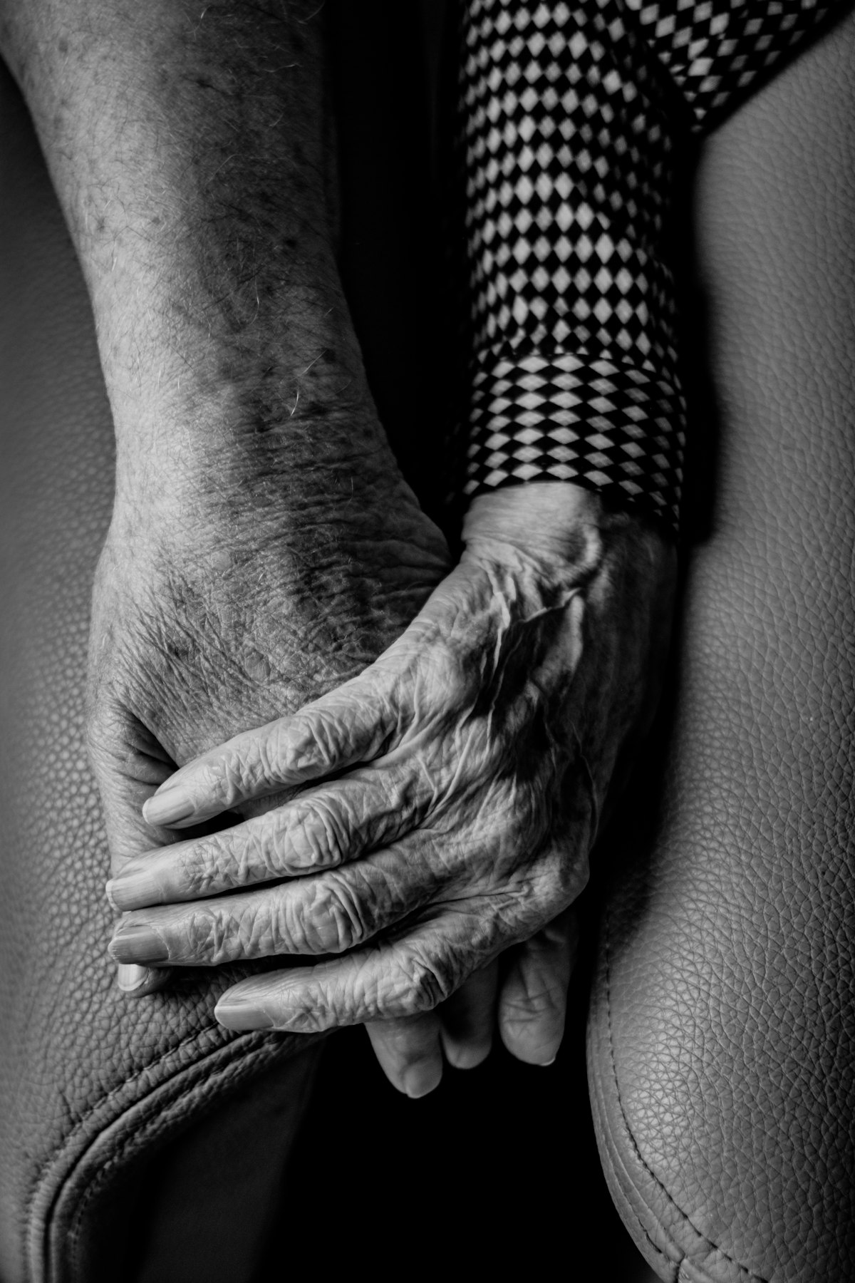 Close-up of two hands holding gently, representing care and support