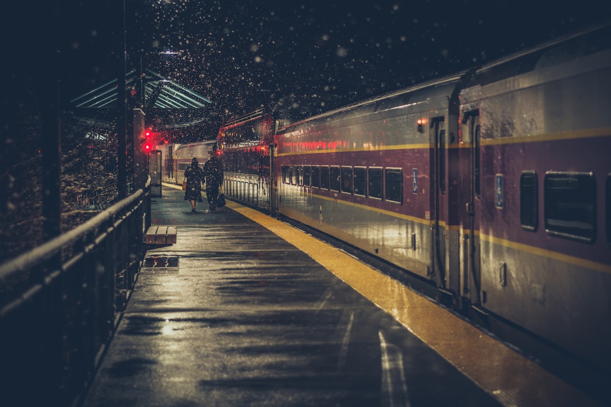 An older couple walking together at a UK train station