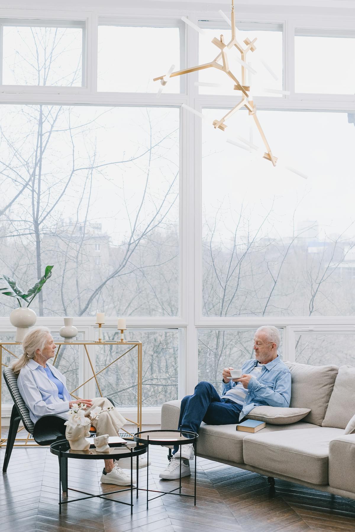 An older couple relaxing comfortably in a warm, well-insulated home